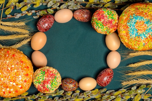 Easter bread with branches of willow pysanka on a monochrome blue background texture