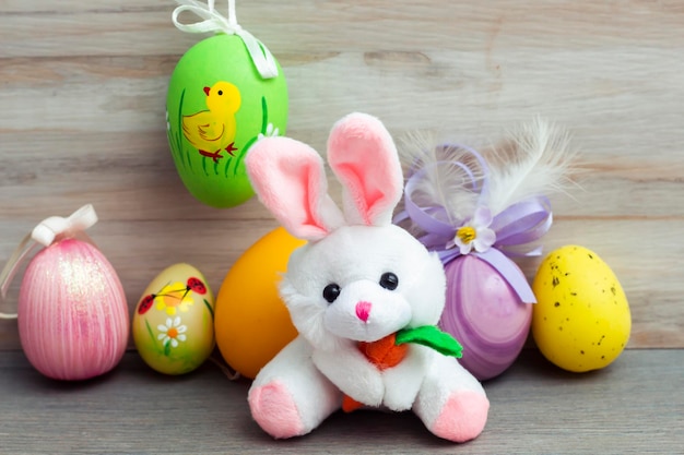 Easter bunny and eggs on wood background