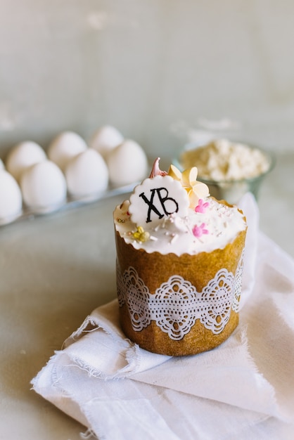 Easter cake on a background of chicken eggs and flour. Sweet cake recipe.