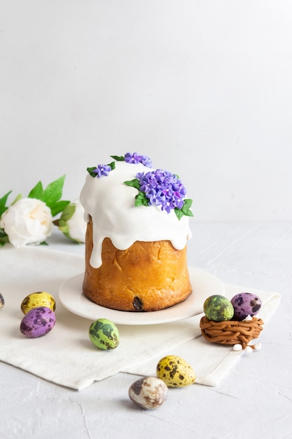 Easter cake colorful eggs and flowers composition on white background