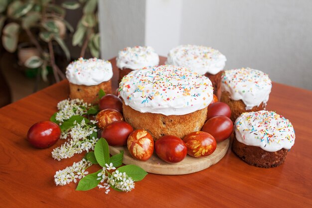 Easter cake and painted eggs. Easter orthodox sweet bread, kulich and colorful quail eggs.