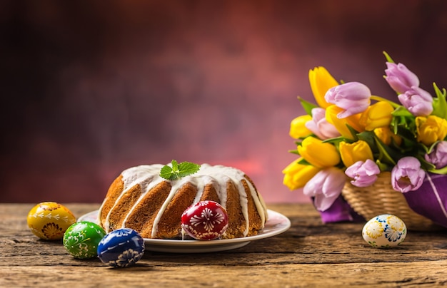 Easter Cake. Traditional ring marble cake withe easter decotation. Easter eggs and spring tulips.