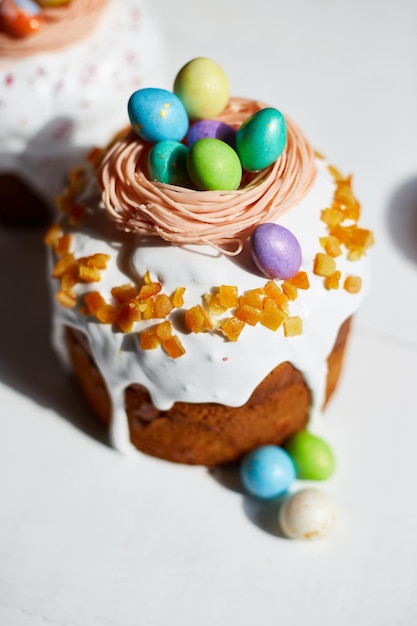 Easter cake with chocolate eggs decoration on white wooden table