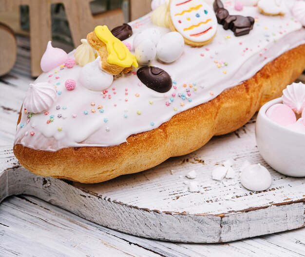 Easter cake with meringue decorated with chocolate bunny and eggs