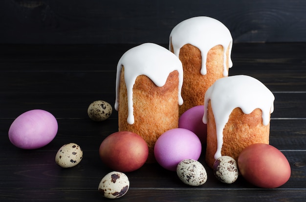 Easter cakes and chicken, quail eggs on a dark background