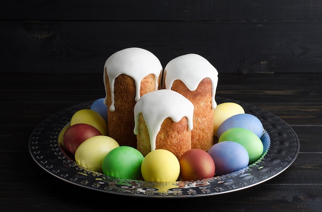 Easter cakes and eggs on a dark, rustic, wooden background