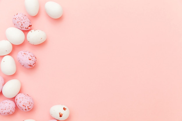 Easter candy chocolate eggs sweets isolated on pink table