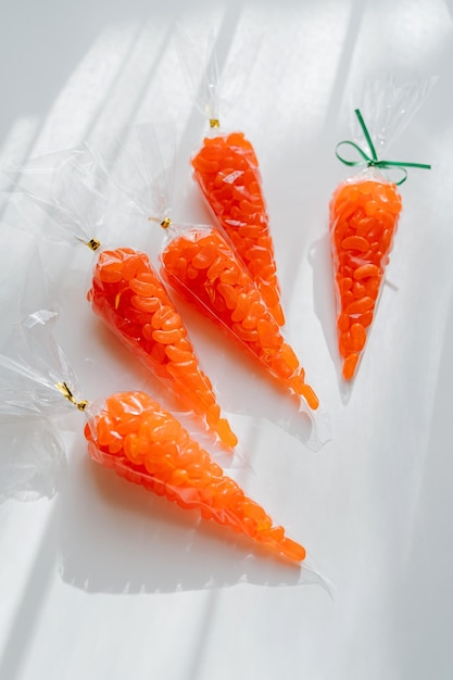 Easter Carrot Treat Bags with Jelly Bean Idea for kids Easter sweets Happy Easter Holiday concept