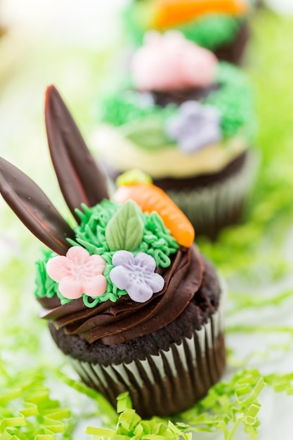 Easter chocolate cupcakes decorated with piggy and bunny ears.