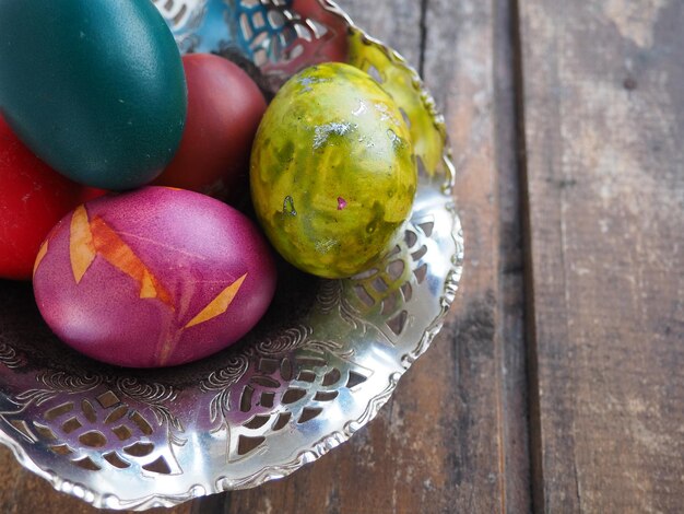 Easter colored eggs in an old metal candy bowl on a wooden table Easter the Resurrection of Christ the Bright Resurrection of Christ the most ancient and Christian holiday