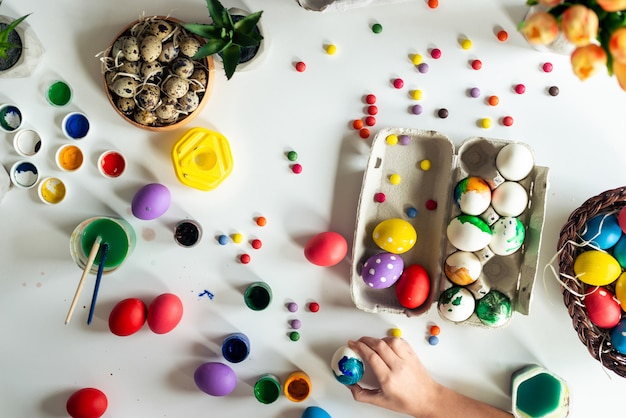 Easter composition with colorful paints and eggs lie on the table. Top view