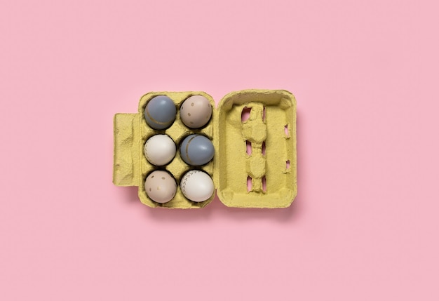 Easter concept. decorated eggs stand in a row on pink background.