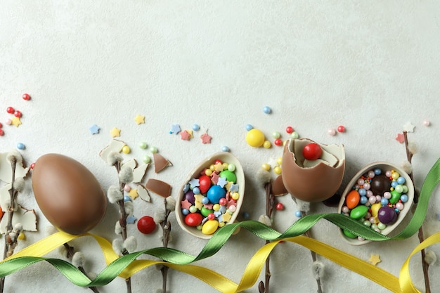 Easter concept with chocolate eggs on white textured surface