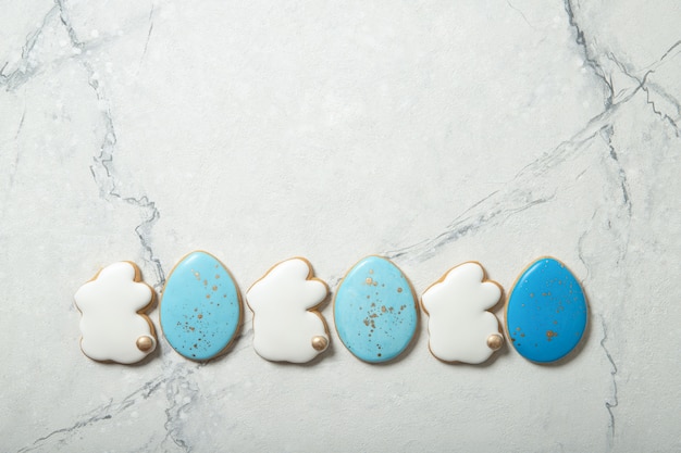 Easter cookies in a plate on a concrete background. Easter bunnies. Place for text. Top view. Place for text.