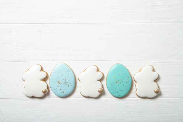 Easter cookies in a plate on a concrete background. Easter bunnies. Place for text. Top view. Place for text.