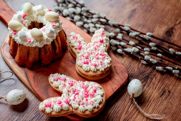 Easter cookies on a wooden board with a bunny shaped bunnies on top