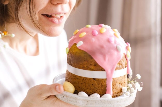 An Easter cupcake in the hands of a woman Easter cake with icing The concept of the Easter background