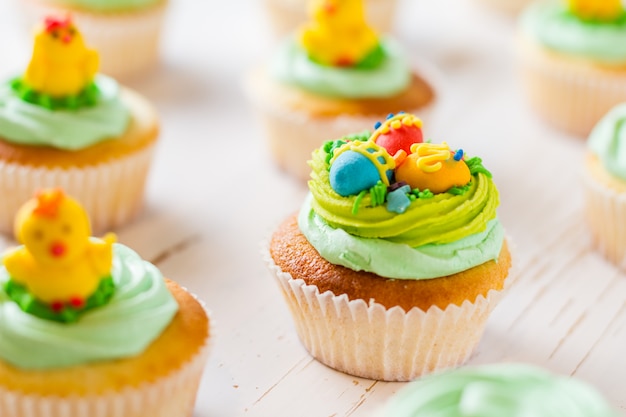 Easter cupcakes on white wood table