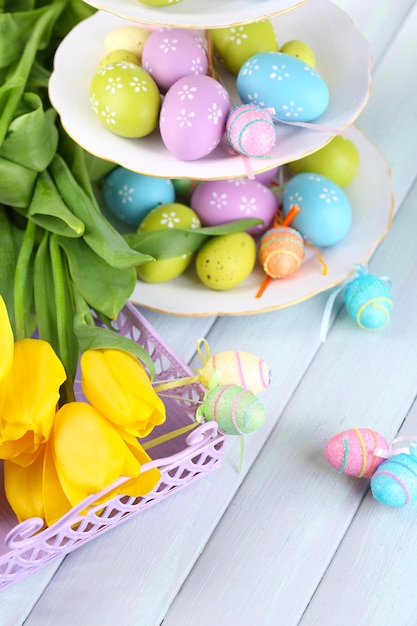 Easter decoration eggs and tulips on table closeup