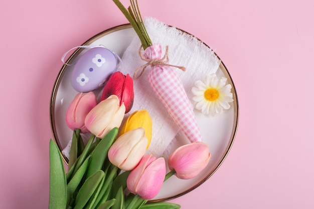 Easter decorations on the table a white knitted napkin Table decoration rabbit carrot and painted eggs