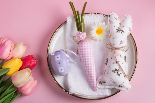 Easter decorations on the table a white knitted napkin Table decoration rabbit carrot and painted eggs