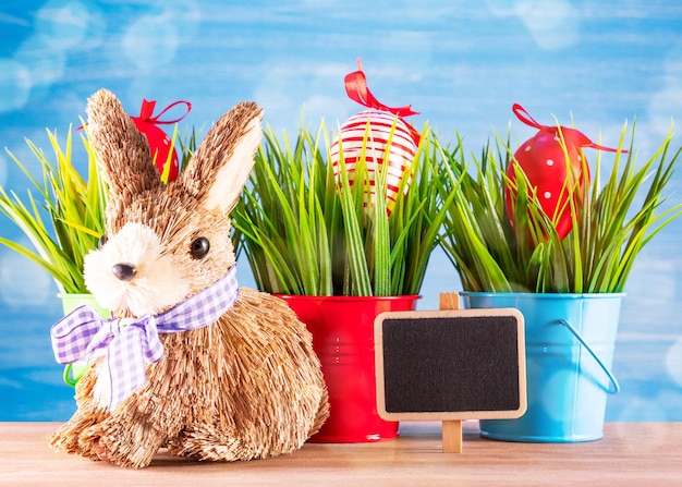 Easter egg and cute bunny on wood table with green grass Festive decoration