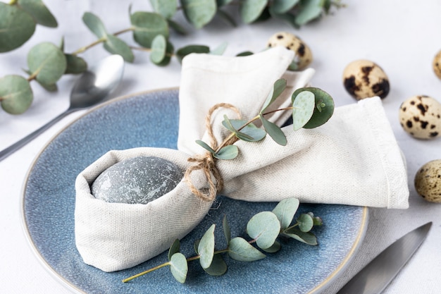 Easter egg inside a napkin and beautiful table decoration