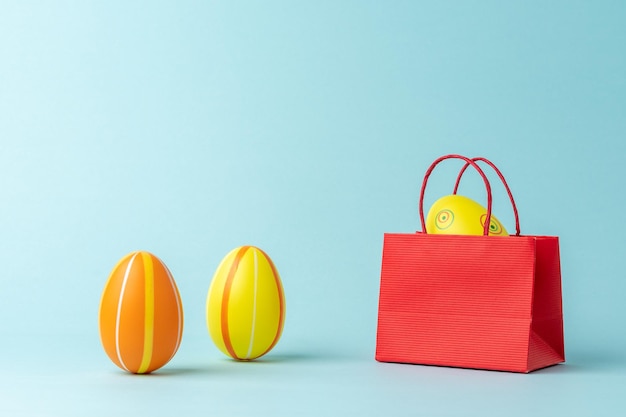 Easter egg in shopping bag on blue background