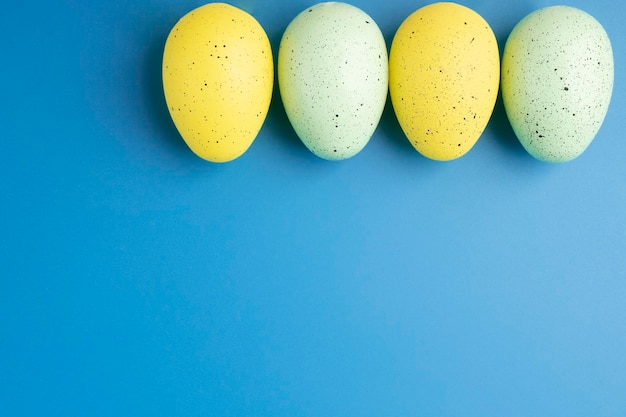 Easter eggs on a blue background blank for design with copy space