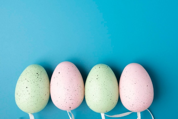 Easter eggs on a blue background blank for design with copy space