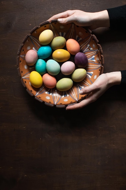 Easter eggs in a bowl on wodden table background in home kitchen