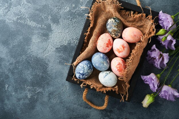 Easter eggs Dyed Easter eggs with marble stone effect ref and blue color in rustic style on dark stone background Easter background Top view