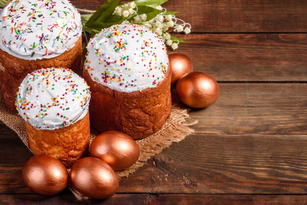 Easter eggs gold and bronze and Easter cake. Preparation for the holiday