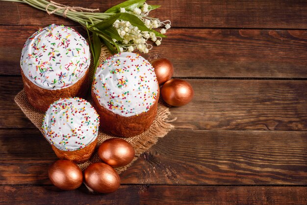 Easter eggs gold and bronze and Easter cake. Preparation for the holiday