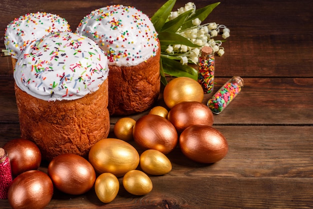 Easter eggs gold and bronze and Easter cake. Preparation for the holiday