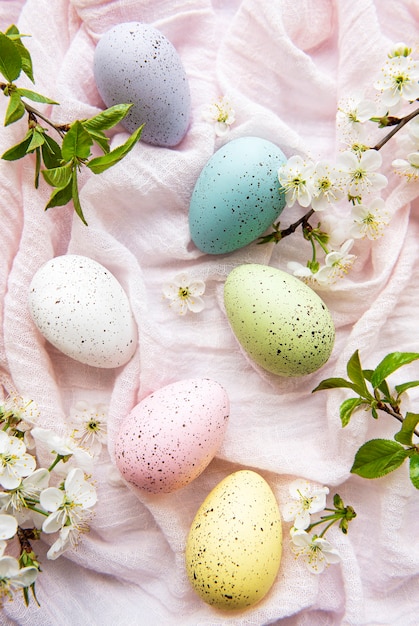 Easter eggs on pink fabric with spring cherry blossom