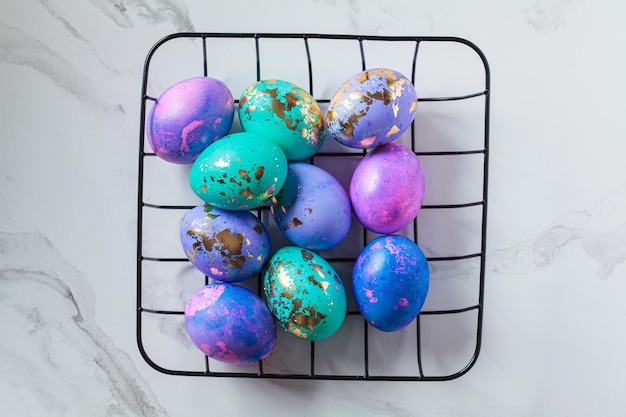 Easter eggs purple and blue with golds on marble background