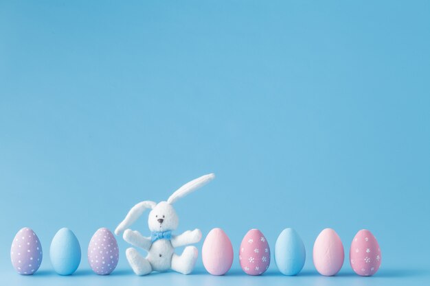 Easter eggs in a row, on blue background