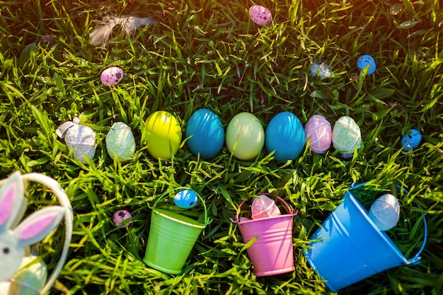 Easter eggs in a row hidden in spring grass