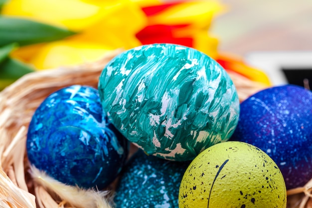 Easter eggs and tulips on wooden planks