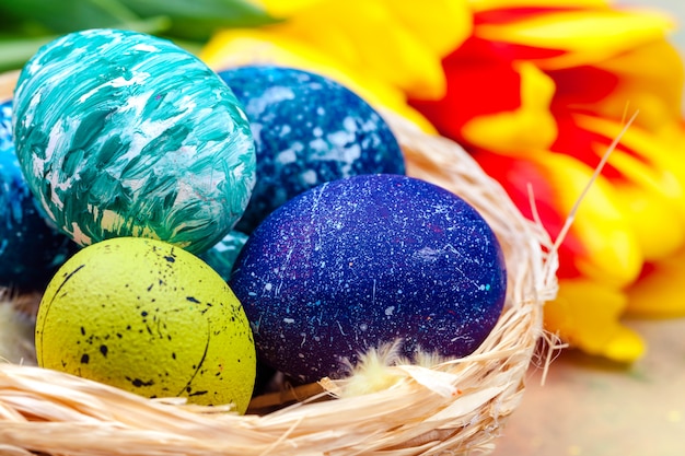 Easter eggs and tulips on wooden planks