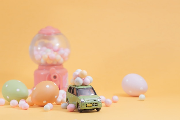 Easter eggs on vintage car with  Egg toy vending machine as Selective focus composition and soft pastel color toned for Easter concept 