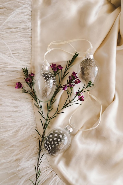 Easter eggs with flowers on white linen fabric Spring and Easter concept