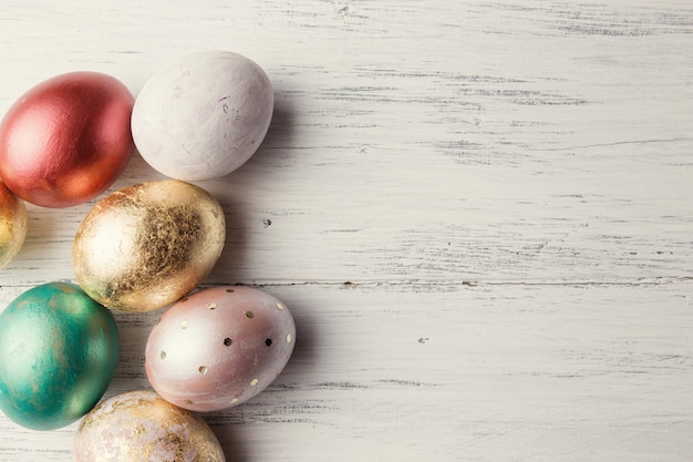 Easter eggs on wooden table. Holiday background