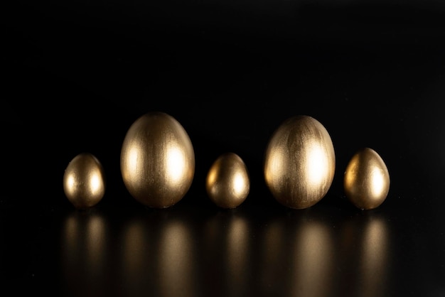 Easter, Gold birds eggs shot against a dark background