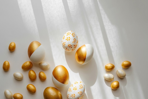 Easter golden eggs and candy on on white background Holiday concept Happy Easter card