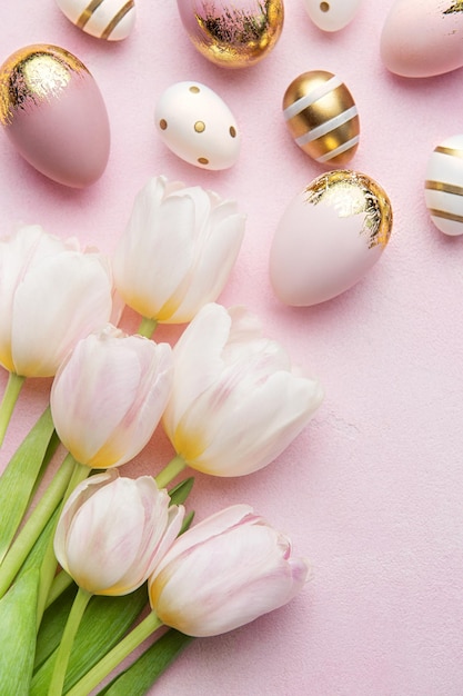 Easter golden eggs and pink tulips on pink background