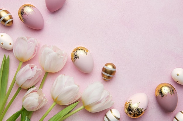 Easter golden eggs and pink tulips on pink background