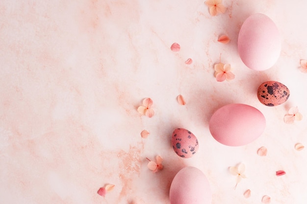 Easter greeting card Easter eggs border and hydrangea flowers on pink marble background