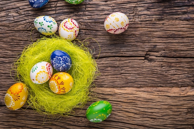 Easter. Hand made easter eggs on old wooden table.